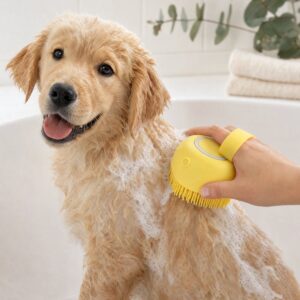 A wet golden retriever puppy getting a gentle bath with the yellow silicone bath brush