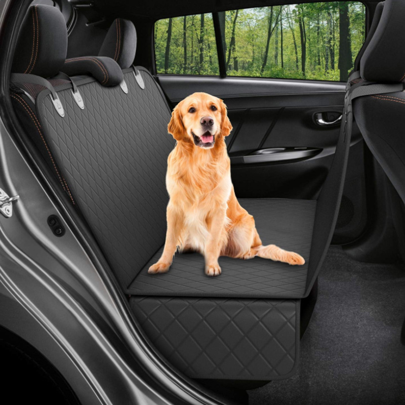 Black quilted dog car seat hammock hooked to the front and back headrests across a back seat